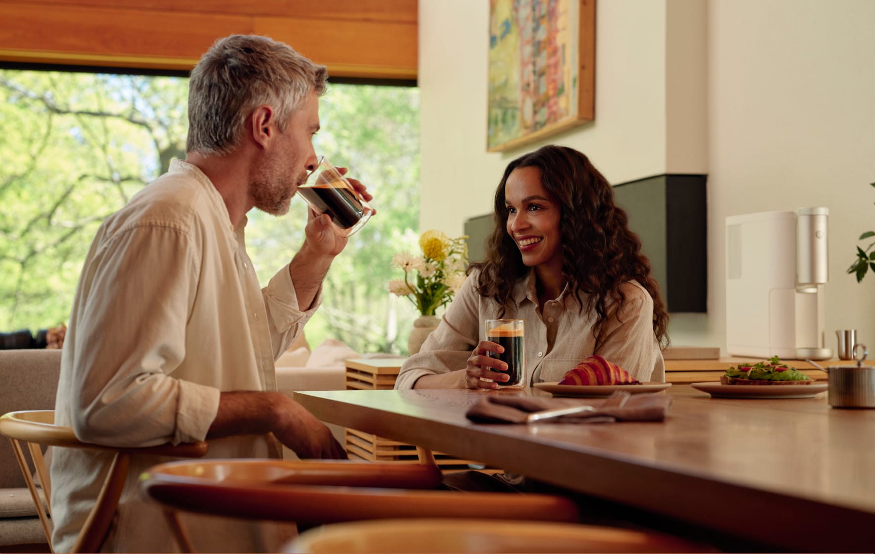 Man and woman enjoying Cumulus Coffee at a table