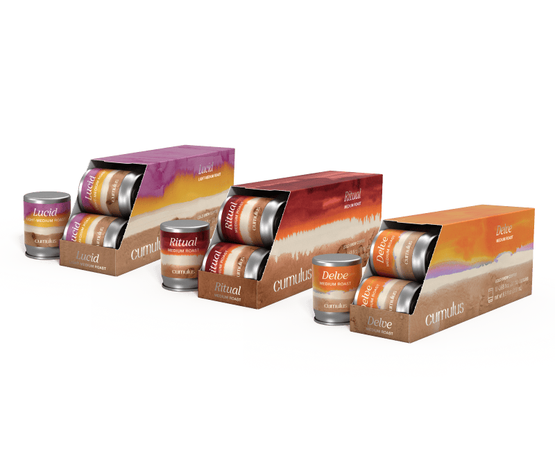 A set of 3 boxes of capsules floating next to each other. The flavors visible are "Ritual medium roast", "Delve medium roast", and "Lucid light medium roast"