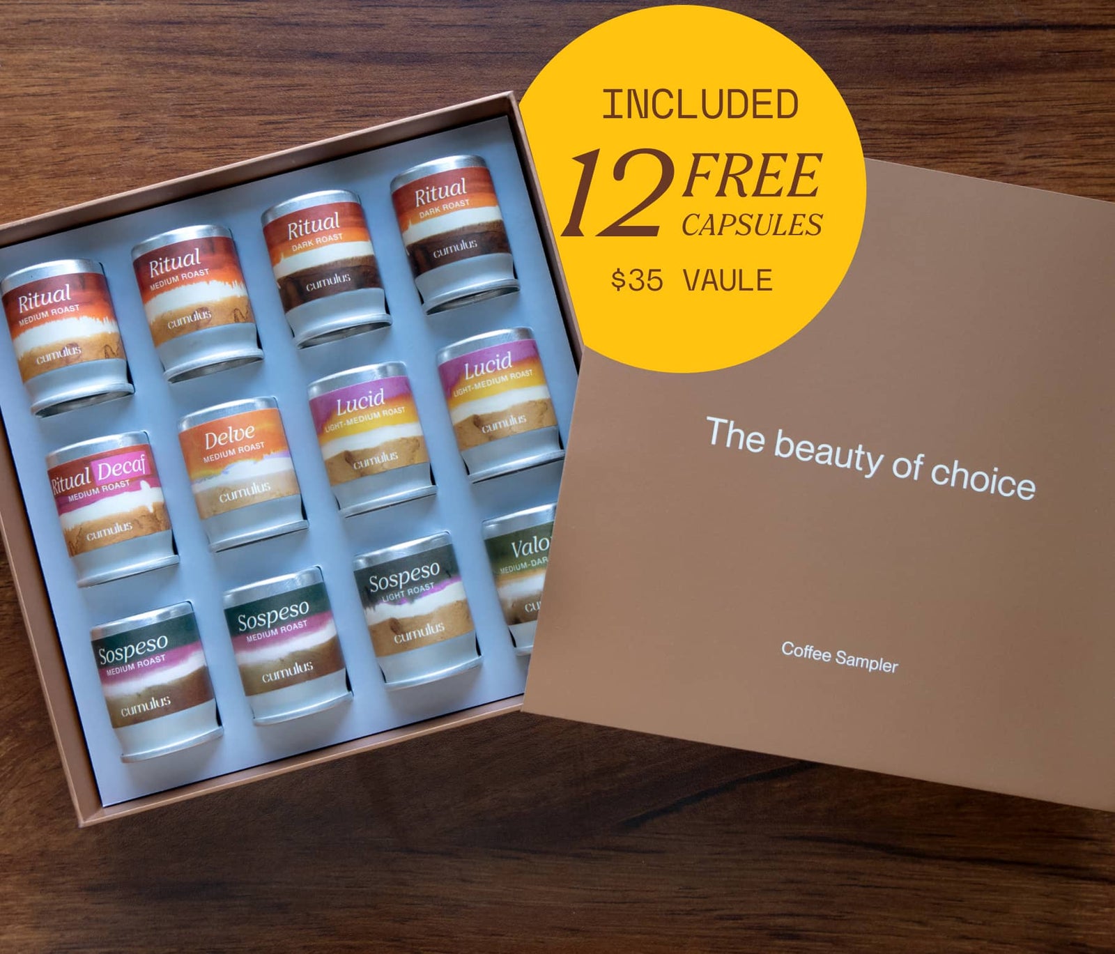 An open box containing 12 flavor capsules with various flavors. A badge on the image says "included 12 free capsules $35 value"