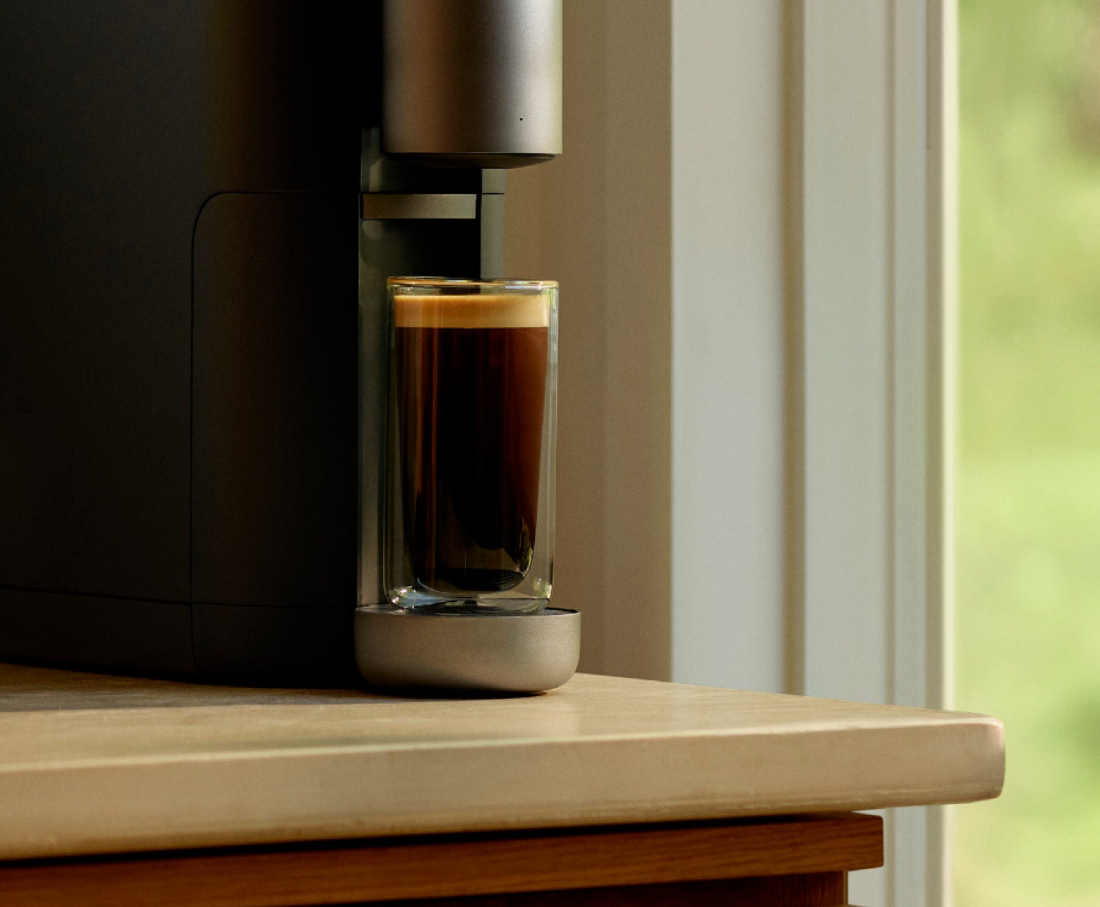 A full cup of coffee in a Cumulus machine on a counter